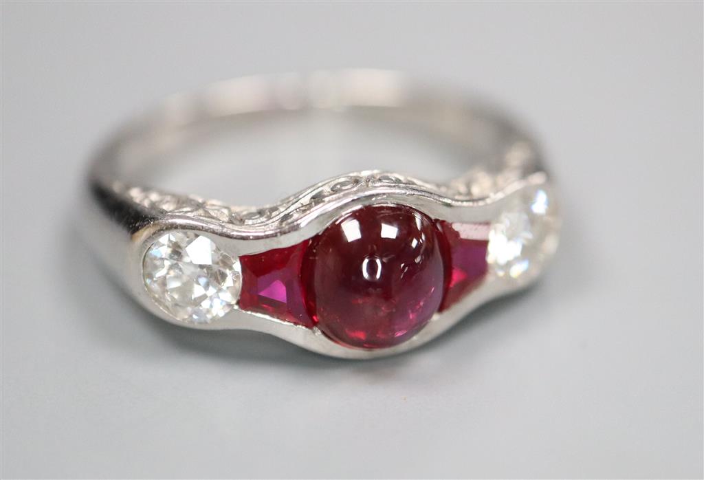 A modern white metal (possibly platinum?), ruby and diamond dress ring,